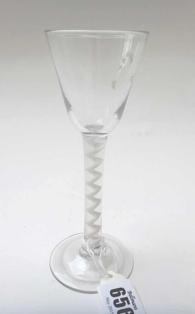 Appraisal: An opaque twist wine glass circa the rounded funnel bowl