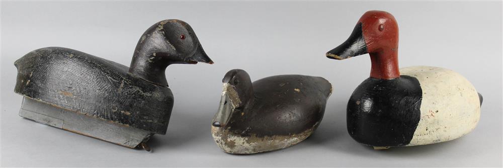 Appraisal: THREE CARVED DUCK DECOYS all unsigned the largest with glass