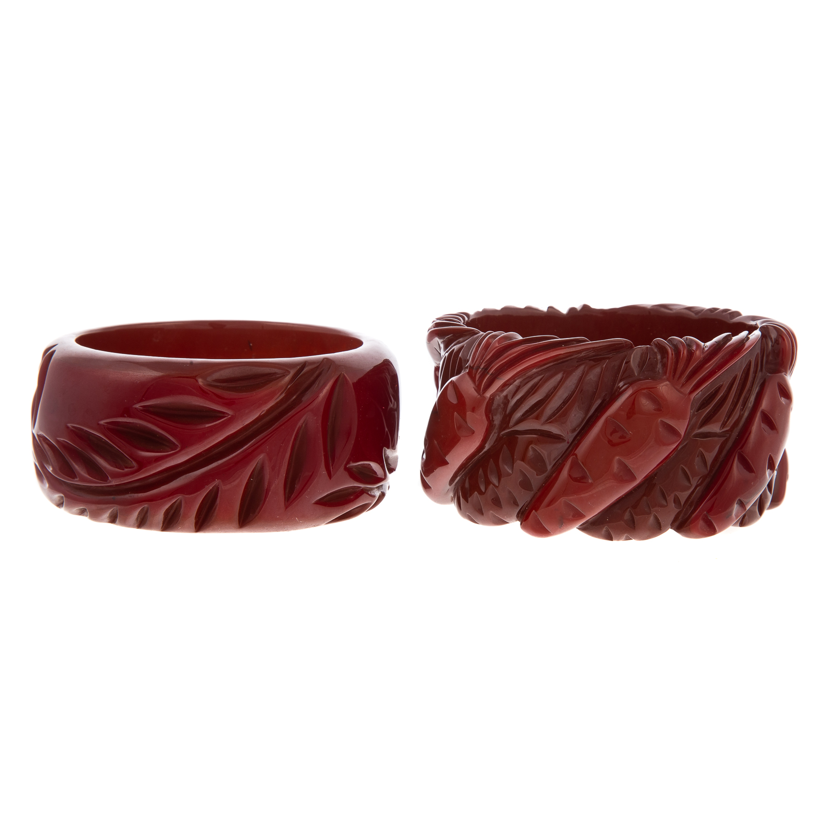 Appraisal: A PAIR OF CARVED BAKELITE BANGLES A fern leaf carved