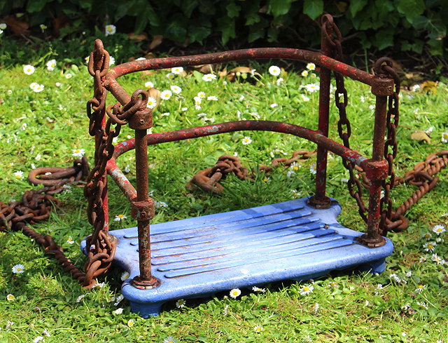 Appraisal: A RED PAINTED WROUGHT IRON AND BLUE SEATED CHILDS SWING