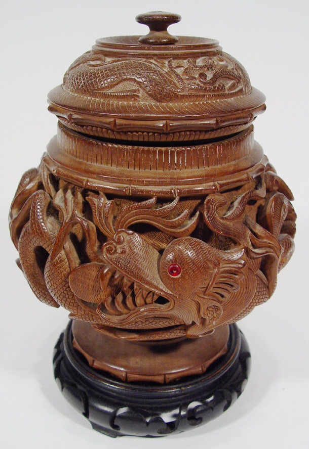 Appraisal: Oriental hardwood jar and cover carved with a continuous band