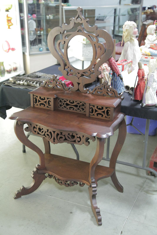 Appraisal: DRESSING TABLE Walnut openwork table having an oval mirror lift