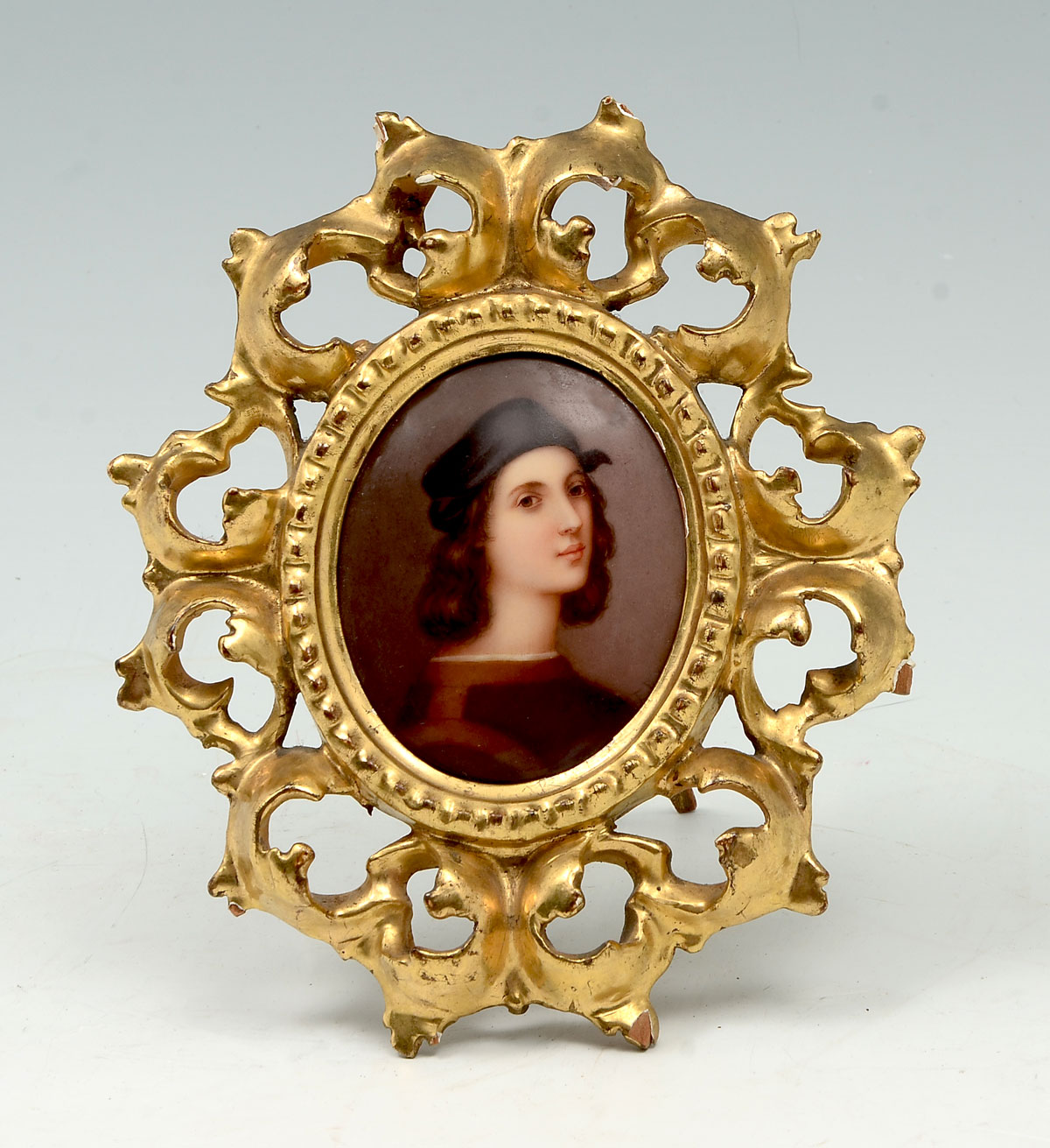 Appraisal: HUTSCHENREUTHER MINIATURE PAINTING ON PORCELAIN Portrait of Young Rafael Oval