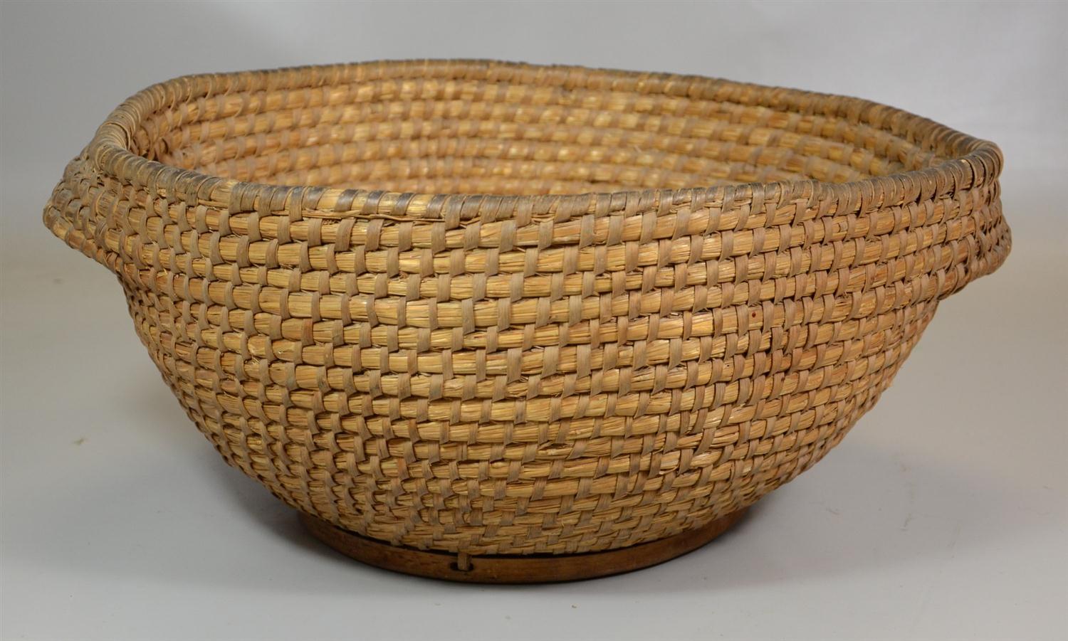 Appraisal: Pennsylvania rye straw basket with exterior woven handles and wooden