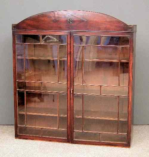 Appraisal: A George III mahogany bookcase top with arched cresting fitted