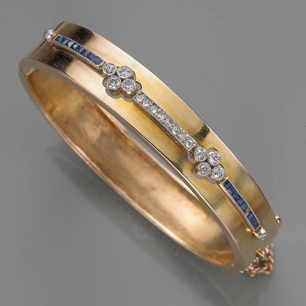 Appraisal: A diamond sapphire and fourteen karat gold bangle bracelet size