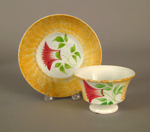 Appraisal: Yellow spatter cup and saucer th c with thistle decoration