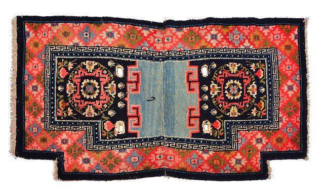 Appraisal: A TIBETAN SADDLE RUG with opposing foliate medallions within a