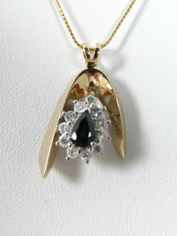 Appraisal: k yellow gold pear shape sapphire and diamond pendant MSRP