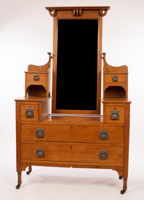 Appraisal: An Art Nouveau oak dressing table the mirror back flanked