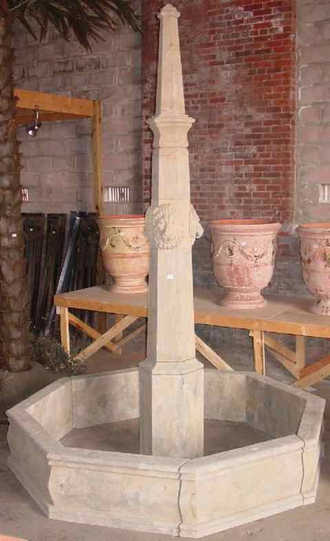 Appraisal: LARGE STONE FOUNTAIN Central column carved with lion's mask enclosed