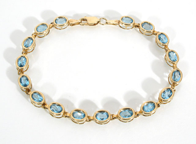 Appraisal: BLUE TOPAZ AND FOURTEEN KARAT GOLD LINE BRACELET set with