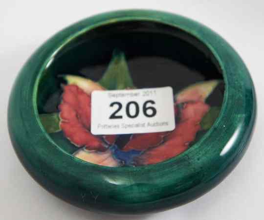 Appraisal: Moorcroft Small Dish decorated with Orchids on Emerald Green diameter