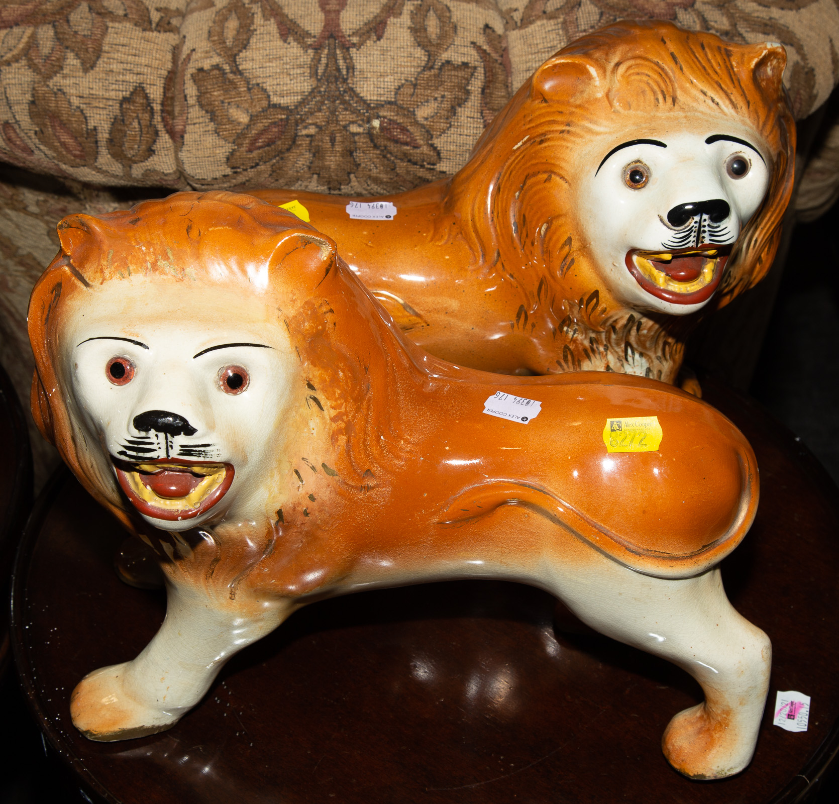 Appraisal: A PAIR OF STAFFORDSHIRE STYLE PORCELAIN LIONS Late th century