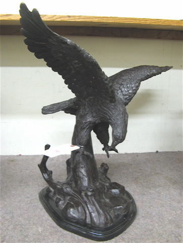 Appraisal: PATINATED BRONZE WILDLIFE SCULPTURE the study of an eagle landing