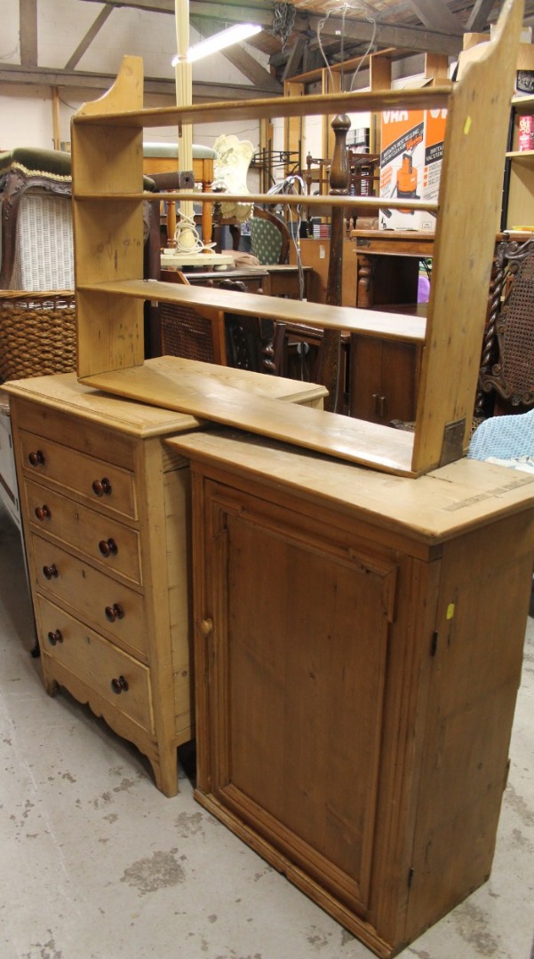 Appraisal: A rustic reclaimed pine hanging cupboard with overhanging cornice above