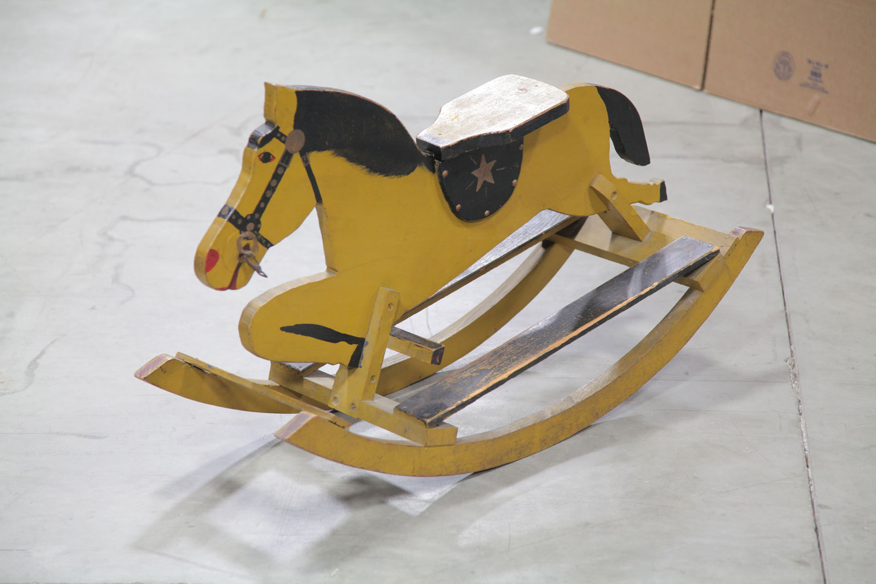 Appraisal: WOODEN ROCKING HORSE American early th century Yellow and black