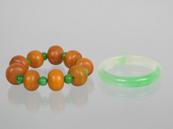 Appraisal: A Carved Jadeite Bangle and a Jadeite and Resin Bracelet