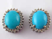 Appraisal: A pair of silver earrings set with blue and clear