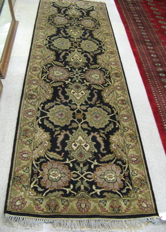 Appraisal: HAND KNOTTED ORIENTAL HALL RUG Indo-Persian floral design on black