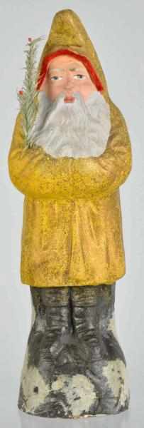 Appraisal: Paper Mache Belsnickle Santa Holding Fir Tree Gold coat Condition