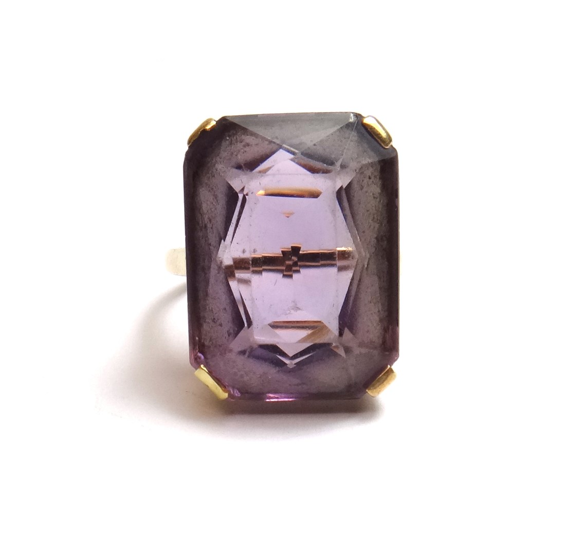 Appraisal: A gold ring claw set with a cut cornered rectangular