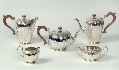 Appraisal: A FIVE PIECE TEA SET the teapot of panelled melon