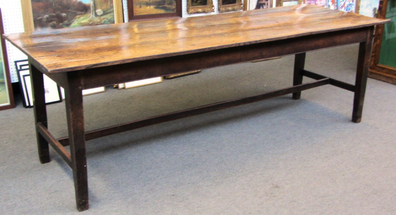 Appraisal: An early th century oak rectangular plank top table on