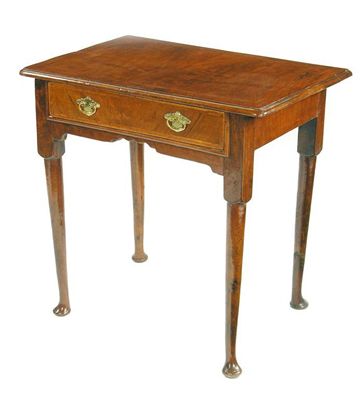 Appraisal: A walnut lowboy the moulded edge top with feather banding