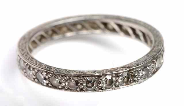 Appraisal: A DIAMOND SET FULL ETERNITY RING mounted in an engraved