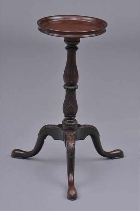 Appraisal: GEORGE III-STYLE CARVED MAHOGANY TRIPOD CANDLESTAND The dished top on