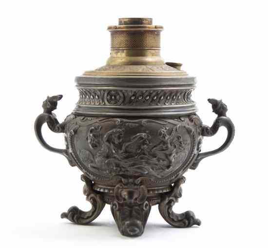 Appraisal: A Continental Cast Metal Kerosine Lamp the base having repousse