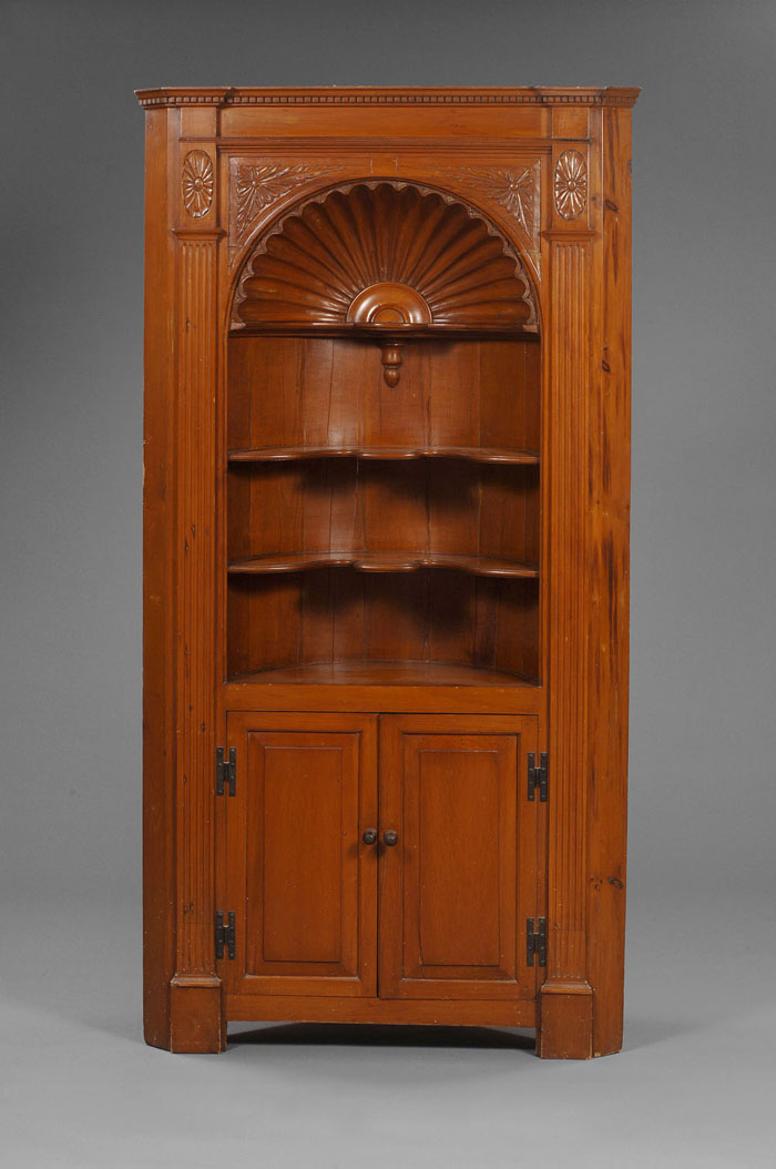 Appraisal: CHIPPENDALE STYLE CARVED PINE ARCHITECTURAL BARREL-FORM CORNER CUPBOARD The dentil-molded