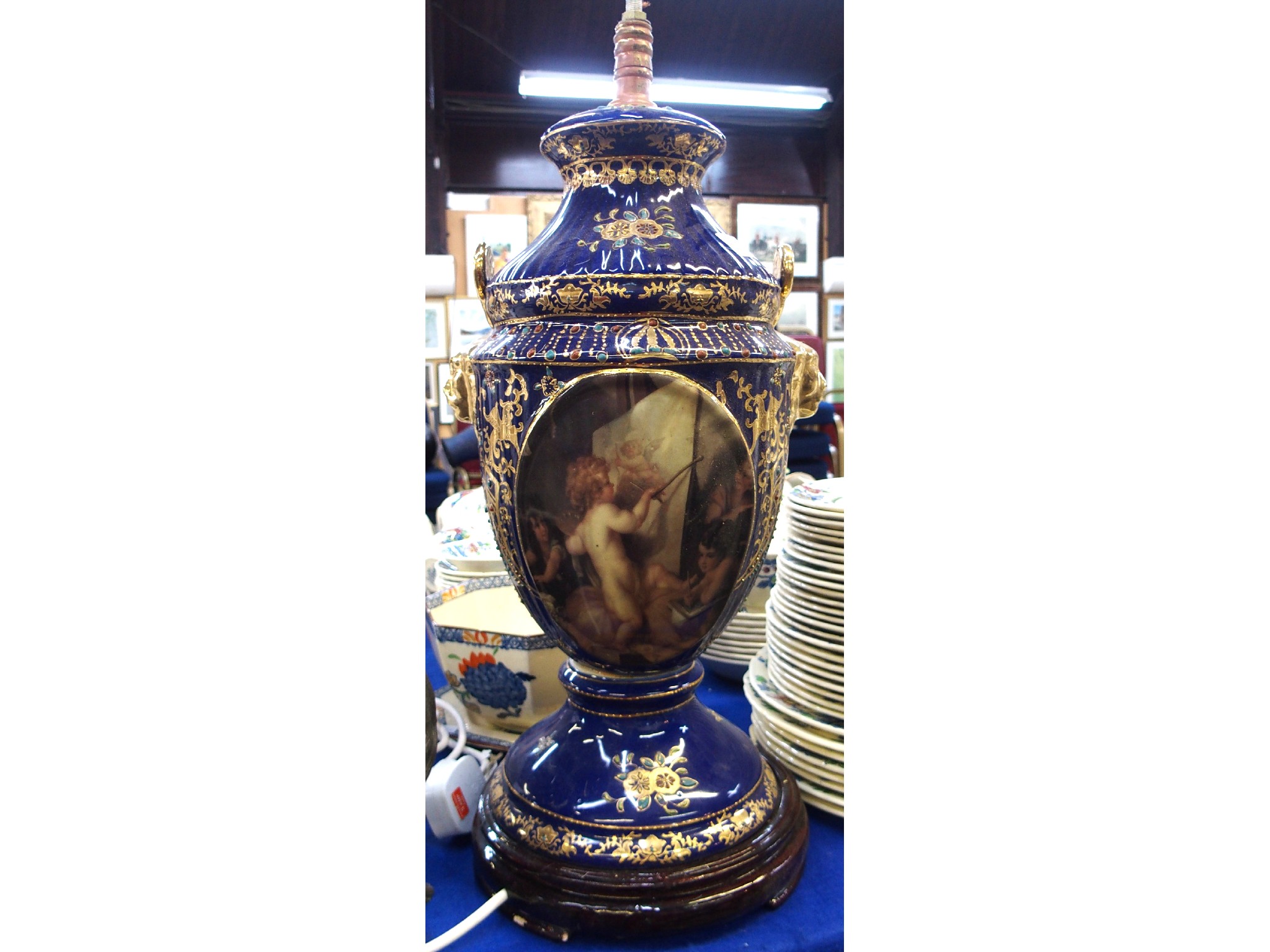 Appraisal: Blue glazed pottery table lamp decorated with cherubs