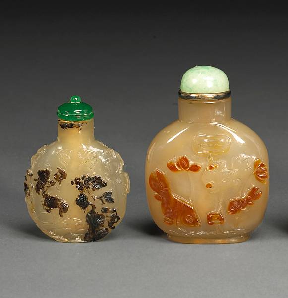 Appraisal: Two agate snuff bottles The first executed from a caramel-toned