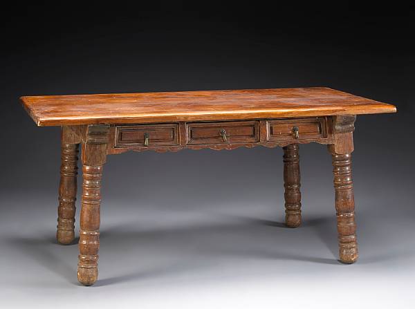 Appraisal: A Spanish Colonial style walnut library table th century The