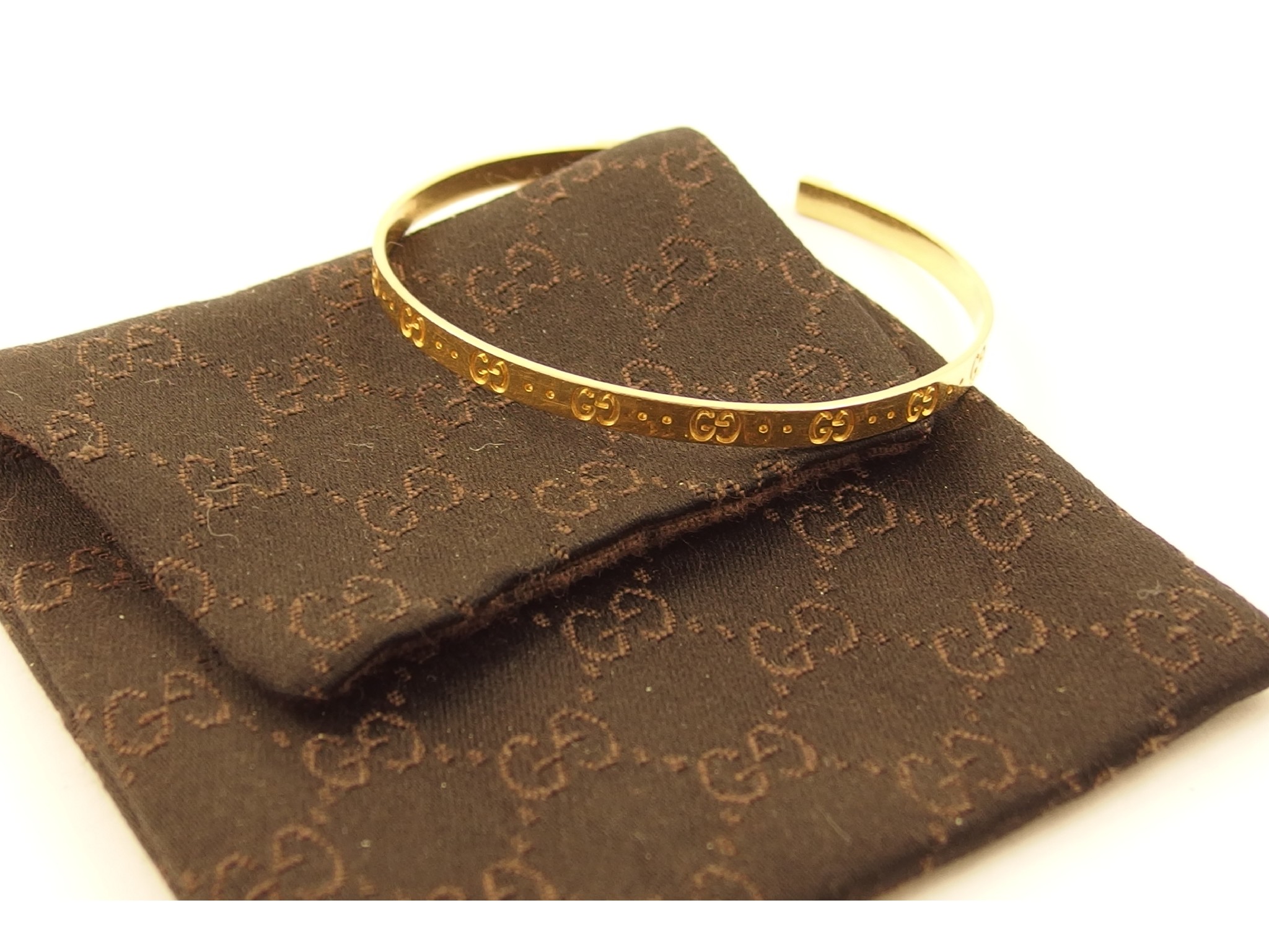 Appraisal: An ct bangle marked with the 'registered sign' Gucci made