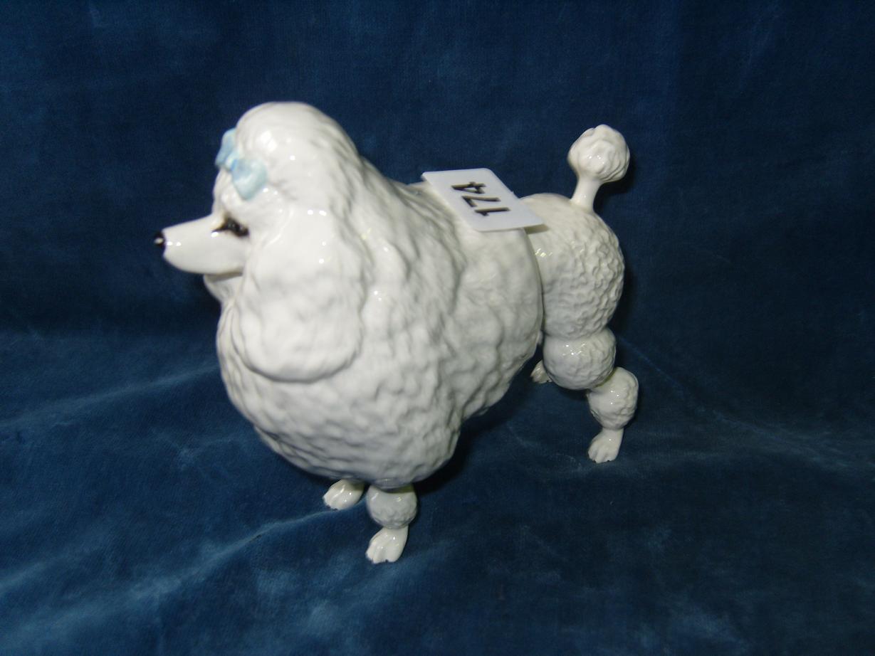 Appraisal: A Beswick model of a white poodle with blue ribbon