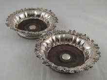 Appraisal: A pair of silver plate ornate wine coasters with detachable