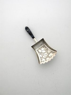 Appraisal: A George III engraved caddy shovel fan-shaped with a multicoloured