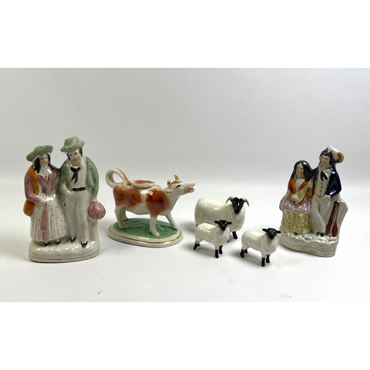 Appraisal: pc English porcelains Beswick rams and Staffordshire Cow Pitcher Dimensions