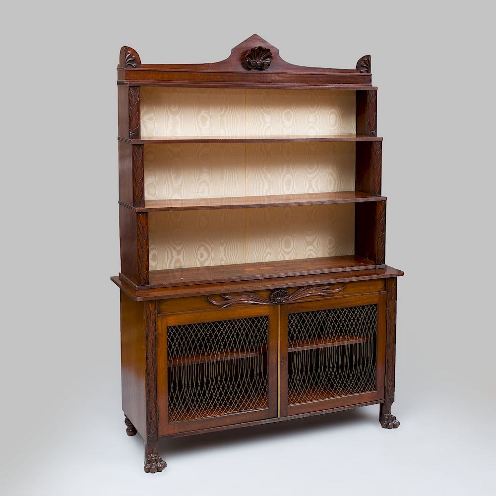 Appraisal: Regency Carved Mahogany Waterfall Bookcase Fitted with silk moir back