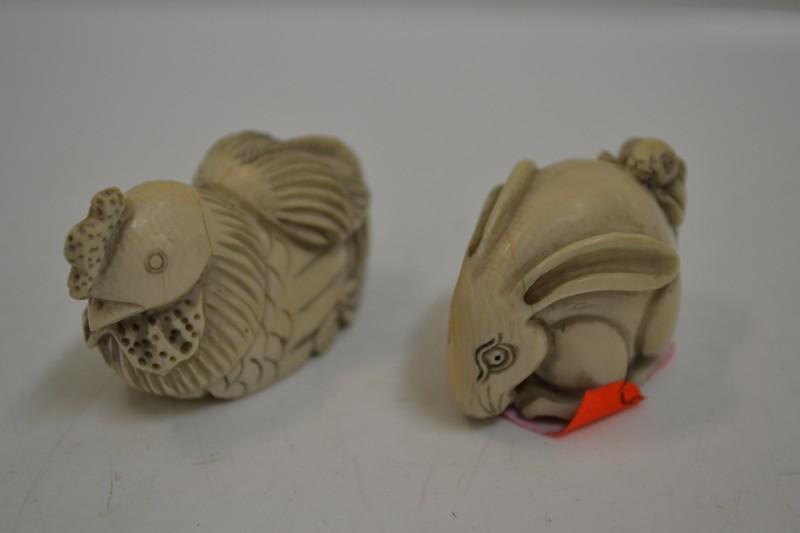 Appraisal: TWO JAPANESE IVORY NETSUKES INCL HARE GROUP AND CHICKEN