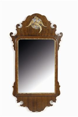 Appraisal: A mahogany fret frame wall mirror with a carved gilt