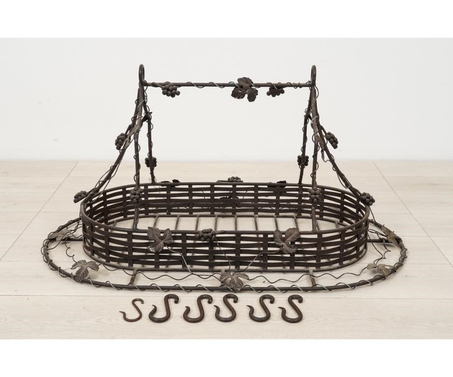 Appraisal: Metal hanging pot rack th c decorated with grape vines