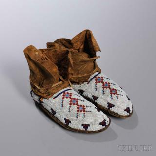 Appraisal: Blackfeet Beaded Buffalo Hide Moccasins c the soft-soled forms beaded