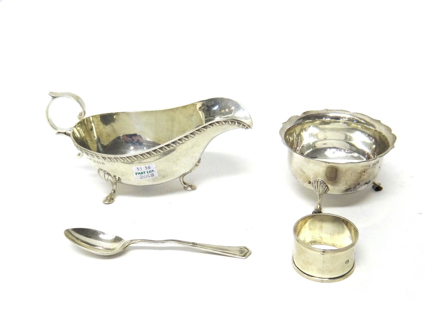 Appraisal: Silver comprising a sauceboat decorated with a gadrooned rim raised