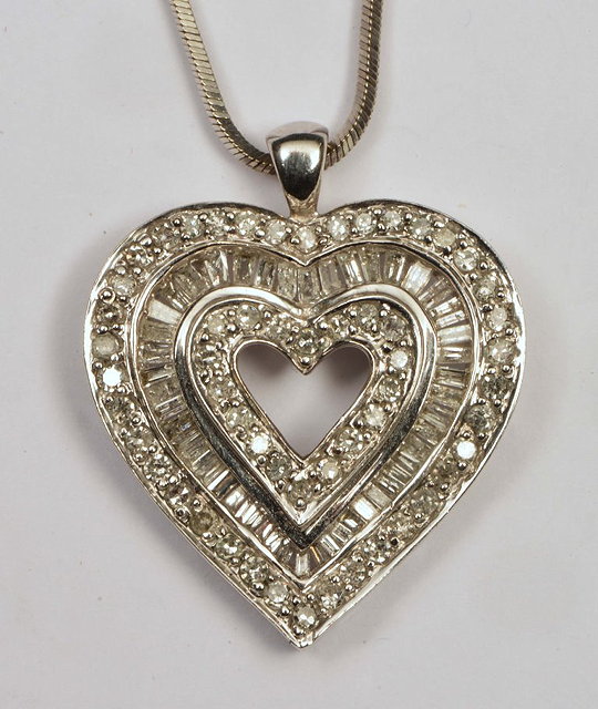 Appraisal: A K WHITE GOLD HEART-SHAPED PENDANT with stylised multi-diamond decoration