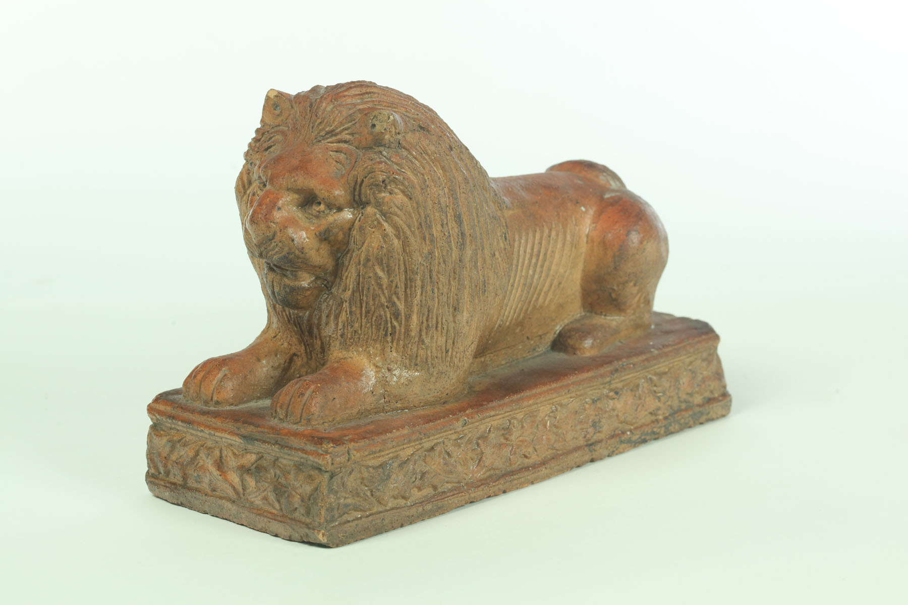 Appraisal: SEWERTILE LION Ohio early th century Reclining lion on molded