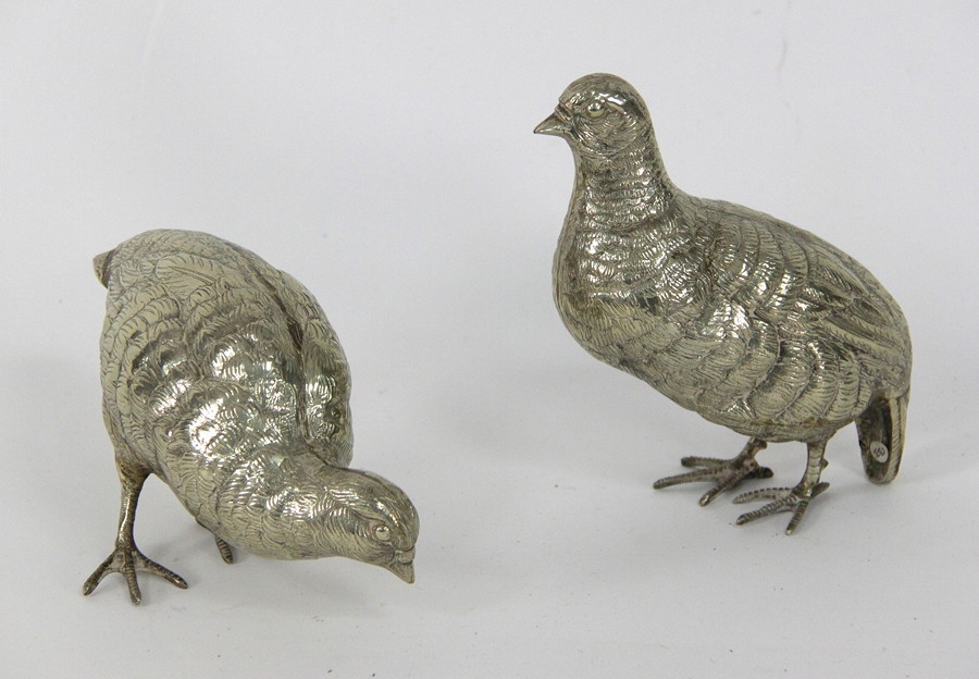 Appraisal: A pair of base metal silvered table ornaments in the